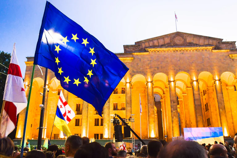 A large blue EU flag in front of a building.