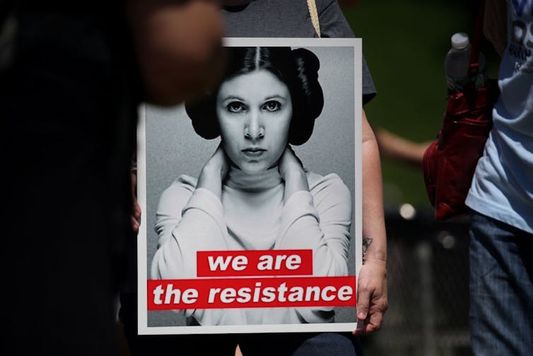 Sign with black and white image of woman.