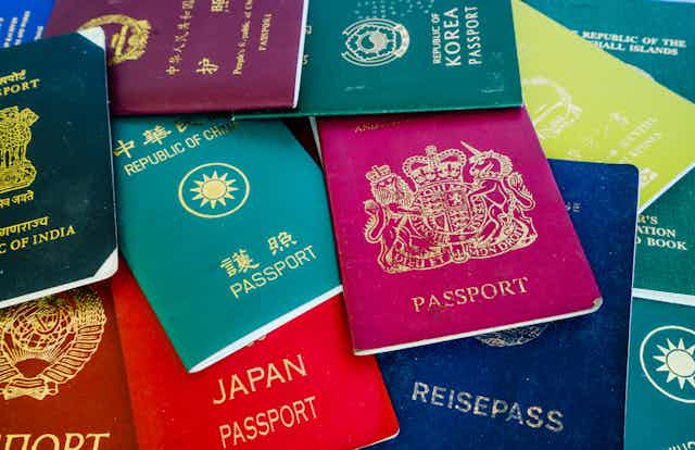 A pile of assorted passports from around the world