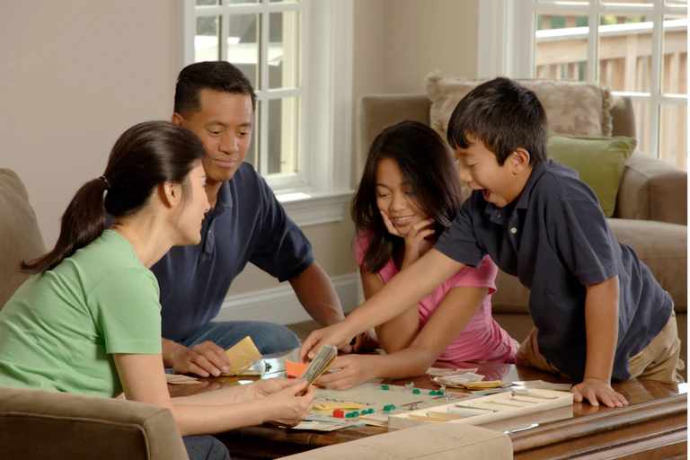 A family sits down to board game