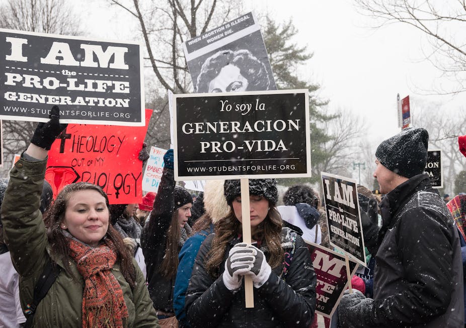 people in winter holding 'pro-life- signs