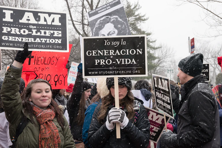 people in winter holding 'pro-life- signs