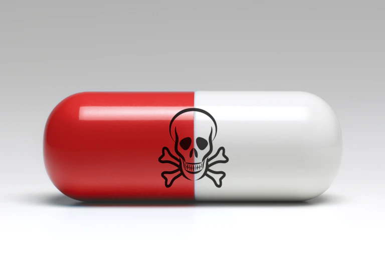 Red and white capsule with skull and crossbones