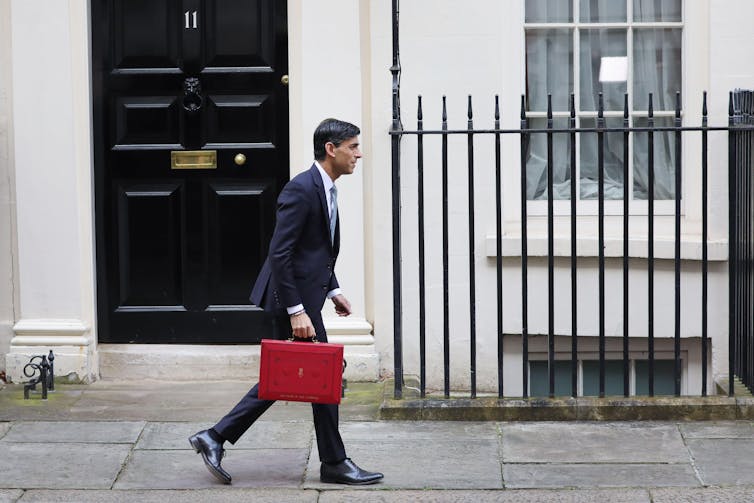 Rishi Sunak outside 11 Downing Street with his ministerial red box in hand.