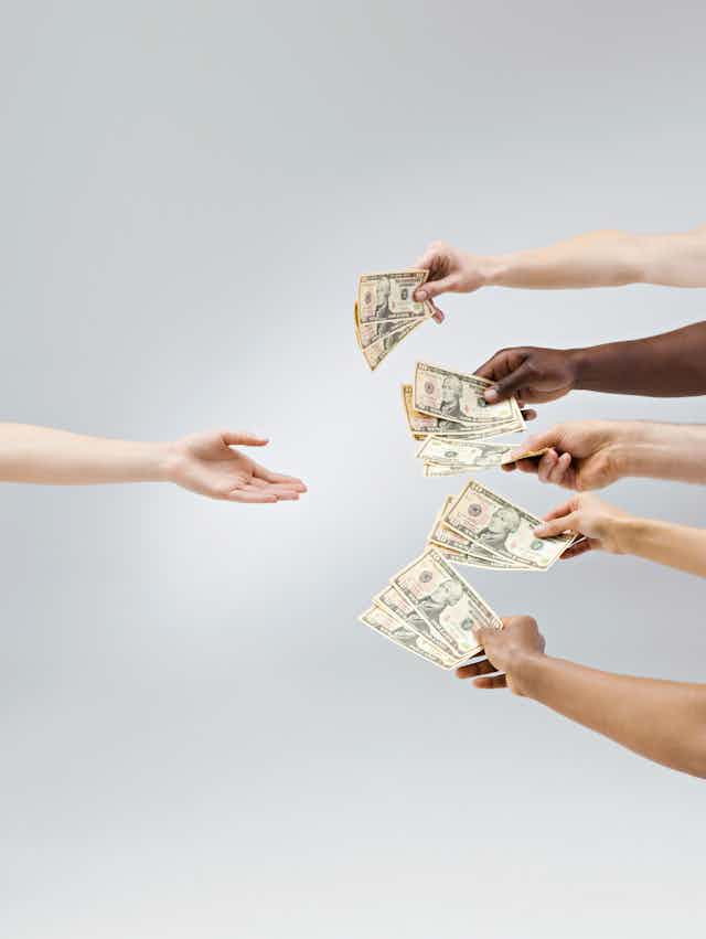 an arm reaches in from the left with palm upraised as four arms reach in from the right each holding cash money