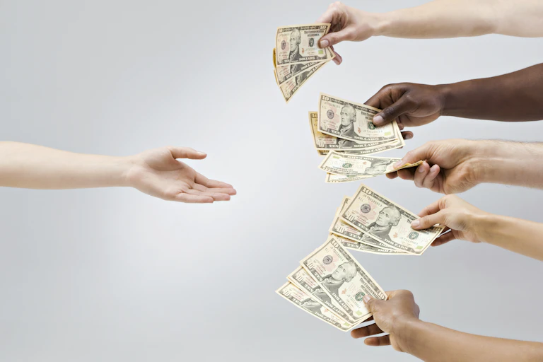 an arm reaches in from the left with palm upraised as four arms reach in from the right each holding cash money