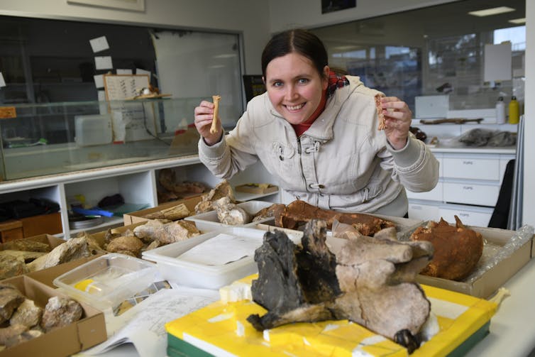 A woman in a lab with fossil bones