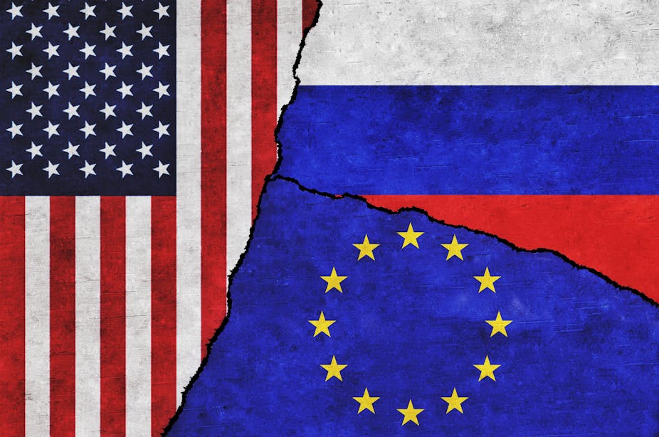 Flags of the United States, Europe and Russia torn apart and joined in the middle to illustrate the crisis 