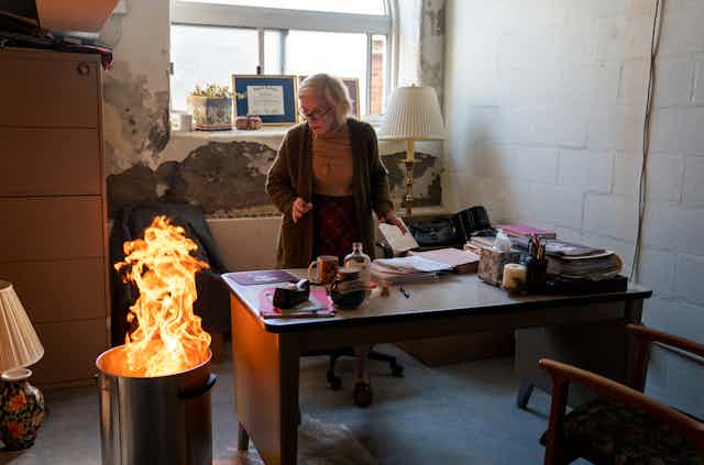 Holland Taylor as Professor Joan Hambling in The Chair, burning her student evaluations.
