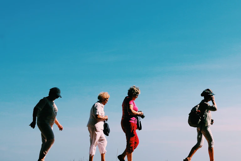 Four older women walking