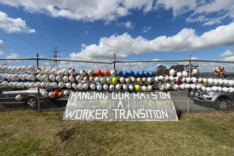 Workers' hats on fence