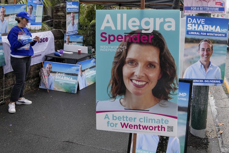woman's face on election poster with person in background