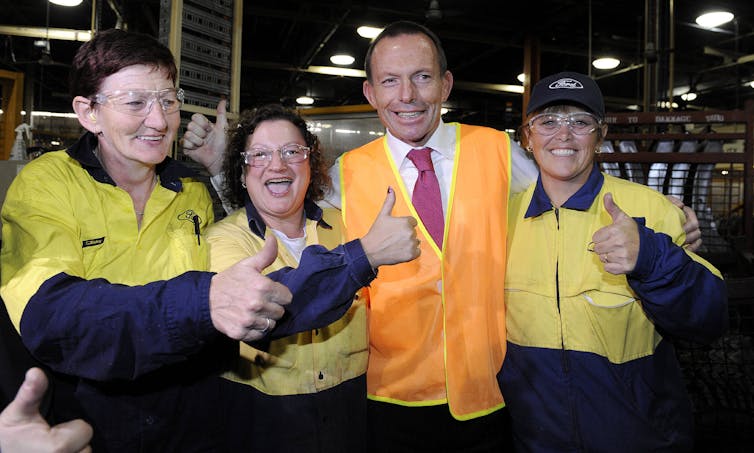 man and three women in high vis smiling