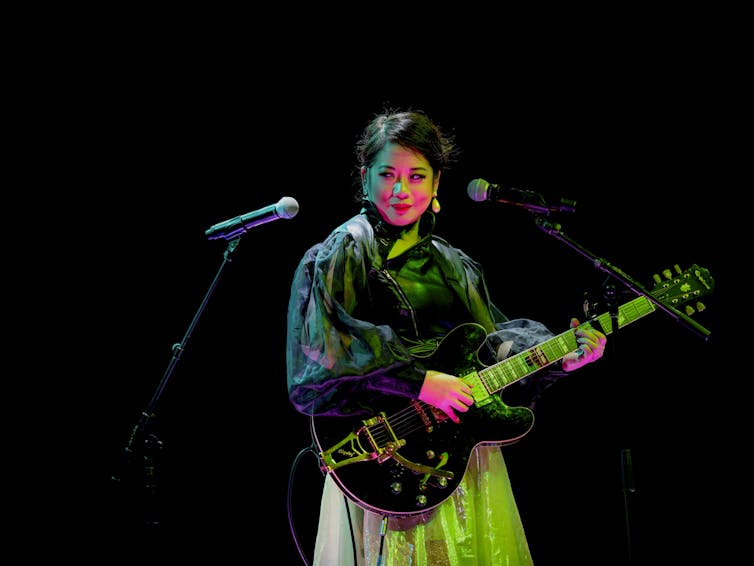 Sophie Koh with a guitar.