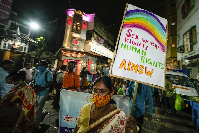 Sex workers and activists walk in a rally demanding right of work in government labor rules