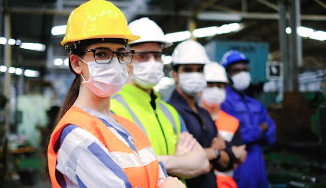 Industrial workers wearing masks