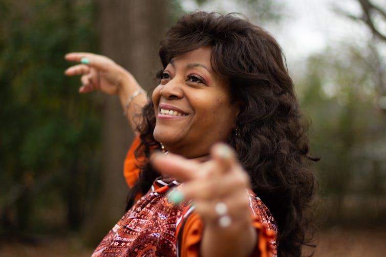 An older Black woman dances