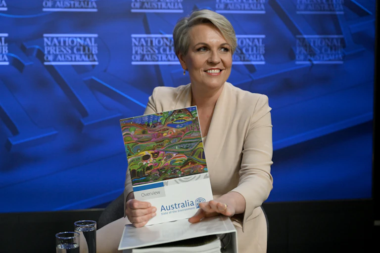 Tanya Plibersek holding a report