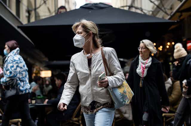 woman in street wearing mask