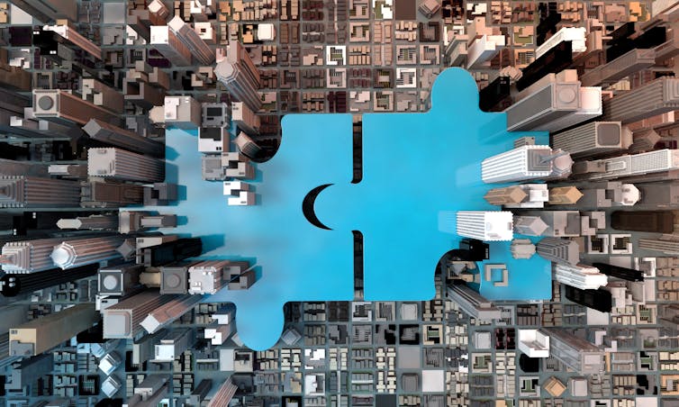 blue puzzle pieces, aerial view of city skyscrapers