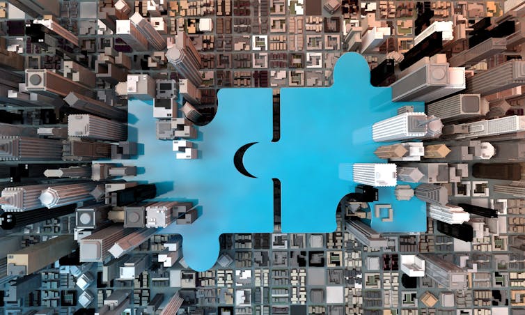 blue puzzle pieces, aerial view of city skyscrapers