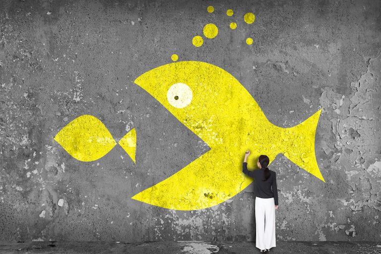 Woman drawing big fish eat small fish on the wall, yellow