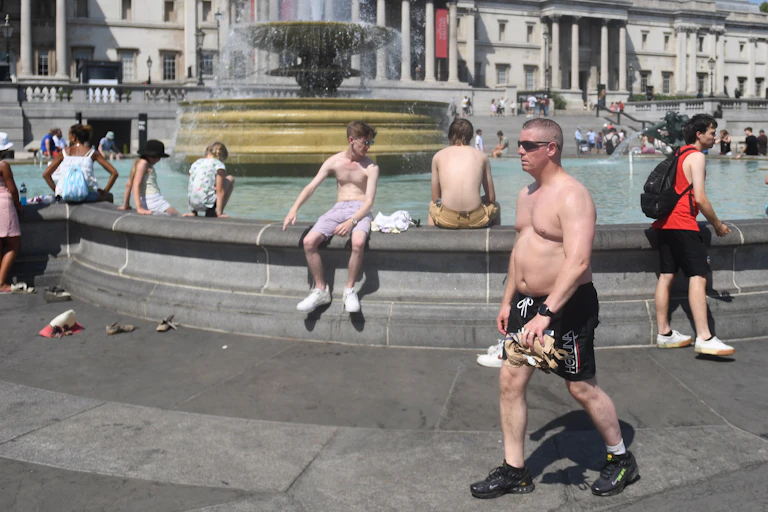 people sit around fountain in the sun