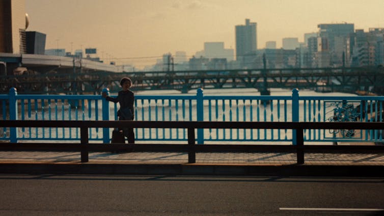 A woman on a bridge