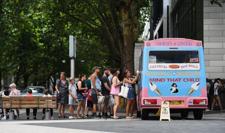 People queue next to ice cream van