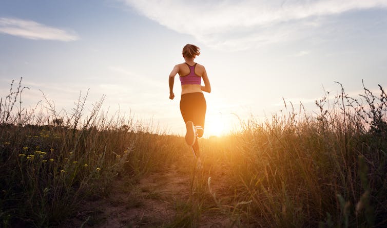 A figure running at sunset