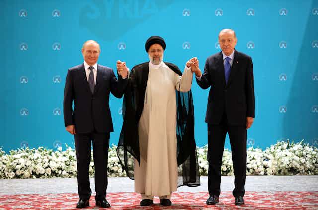 Russian President Vladimir Putin, Iranian President Ebrahim Raisi and Turkish President Recep Tayyip Erdogan pose for a picture during a trilateral summit on Syria in Tehran, Iran, 19 July 2022.