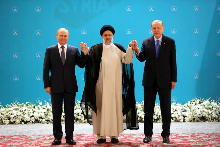 Russian President Vladimir Putin, Iranian President Ebrahim Raisi and Turkish President Recep Tayyip Erdogan pose for a picture during a trilateral summit on Syria in Tehran, Iran, 19 July 2022.