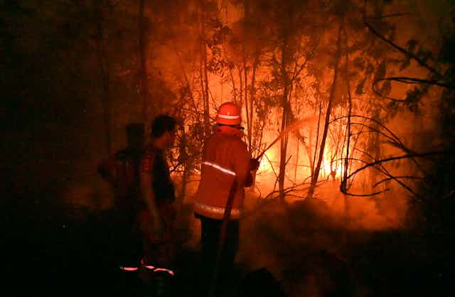 Indonesian firefighters try to put out a blaze. 