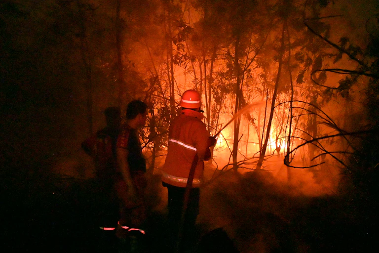 Indonesian firefighters try to put out a blaze.
