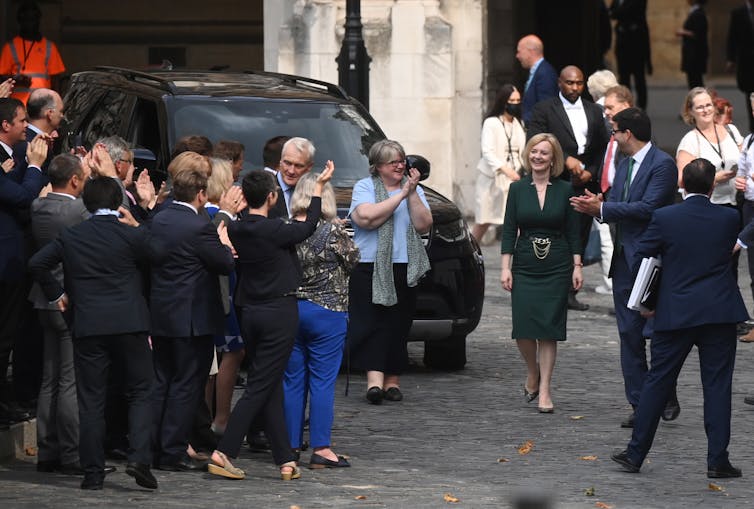 Liz Truss with her supporters outside parliament.