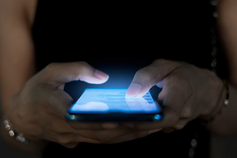 A person scrolling on their phone.