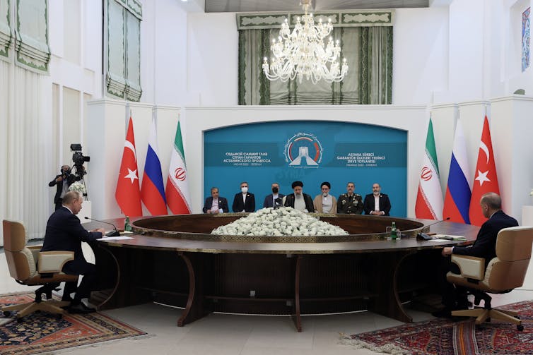 Russian President Vladimir Putin (C), Iranian President Ebrahim Raisi (R) and Turkish President Recep Tayyip Erdogan (L) sit for talks during a trilateral summit on Syria in Tehran, Iran, 19 July 2022.