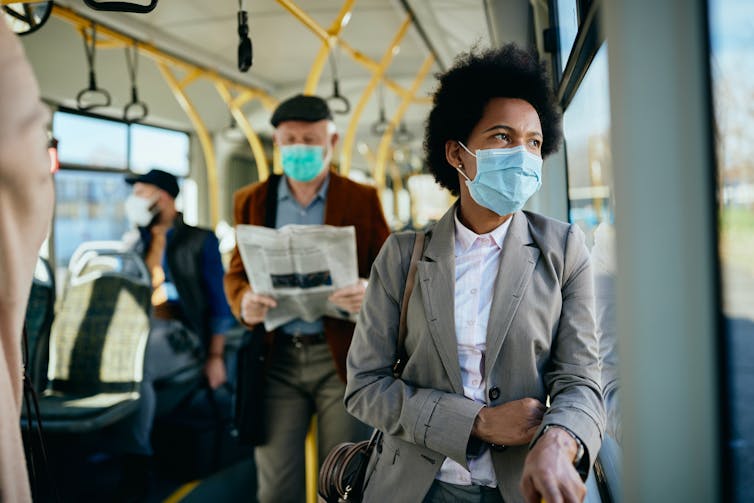 People on public transport wearing masks.