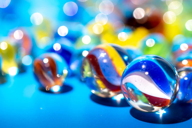 Detail of a marbles with swirls seen against a sparkly marble background.