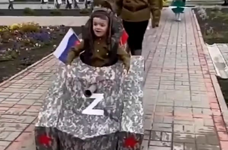 Photo from Twitter showing Russian child dressed as a tank for Victory Day in May 2022.