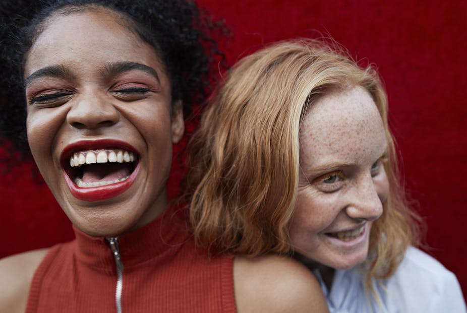 closeup of two young women laughing together