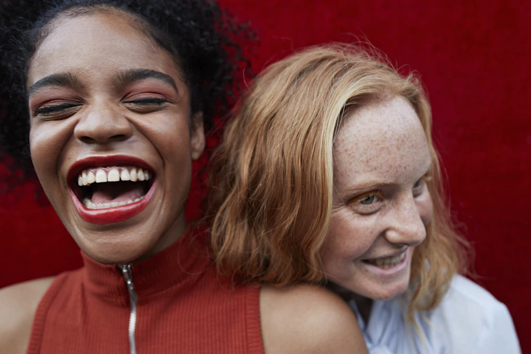 closeup of two young women laughing together