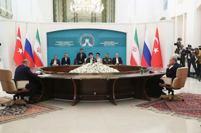 Iran's President Ebrahim Raisi (C), Russian President Vladimir Putin (L), and Turkish President Recep Tayyip Erdogan during a trilateral summit in Tehran, July 2022