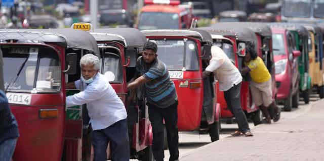 Auto rickshaw drivers line up to buy gas near a fuel station in Colombo, Sri Lanka, Wednesday, April 13, 2022.