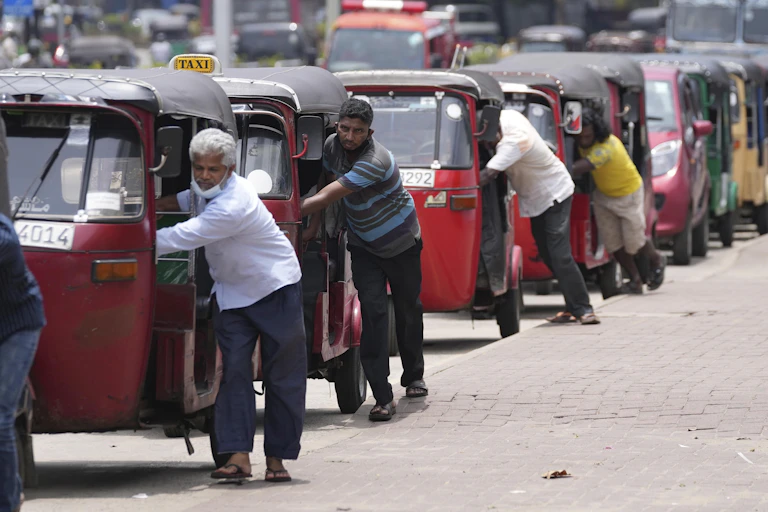 Auto rickshaw drivers line up to buy gas near a fuel station in Colombo, Sri Lanka, Wednesday, April 13, 2022.