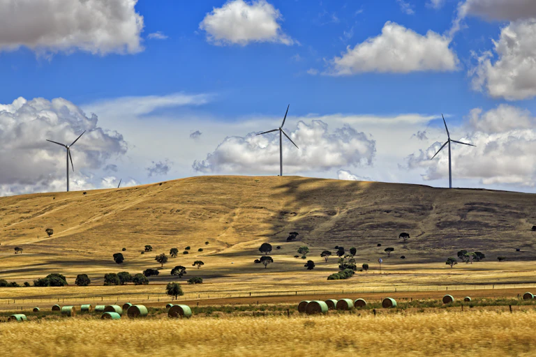 Three wind turbines on a hill