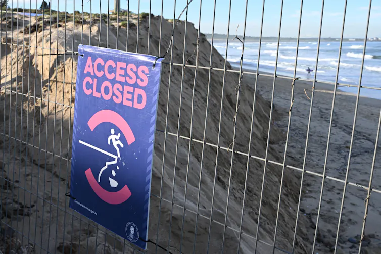 sign saying Access Closed on a fenced-off section of beach