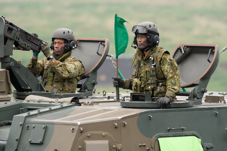 Japan's Ground Self-Defense Forces (JGSDF) soldiers ride a Type 99 155mm self-propelled howitzer, May 2021.