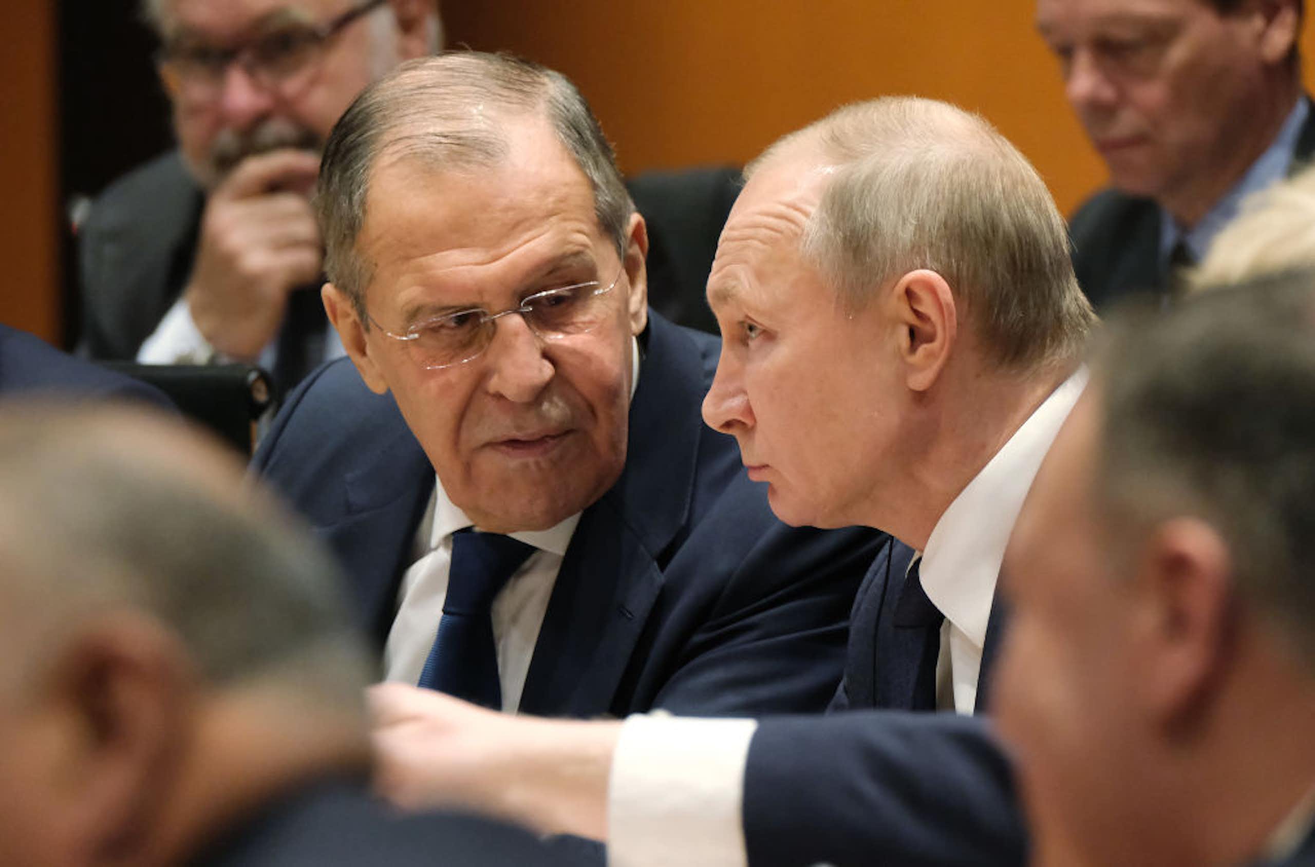 Russian President Vladimir Putin (C) and Russian Foreign Minister Sergey Lavrov (L)