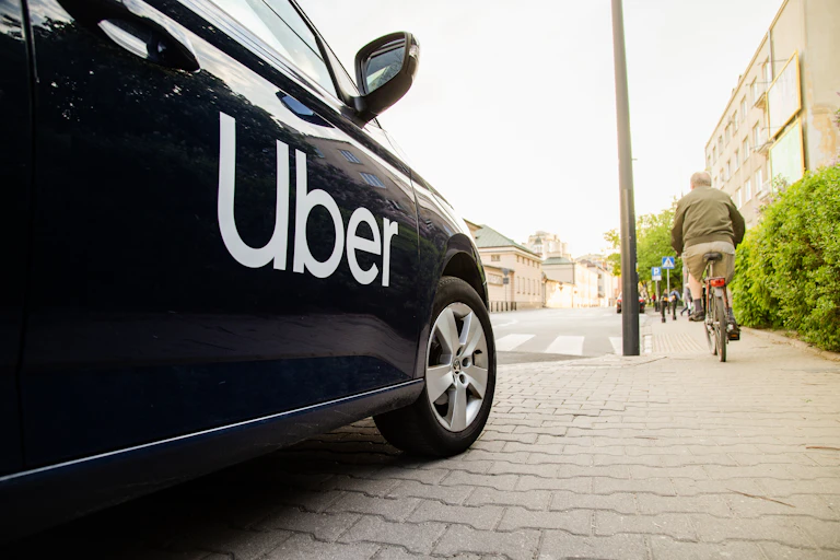 a close up of a black car with UBER printed in white writing